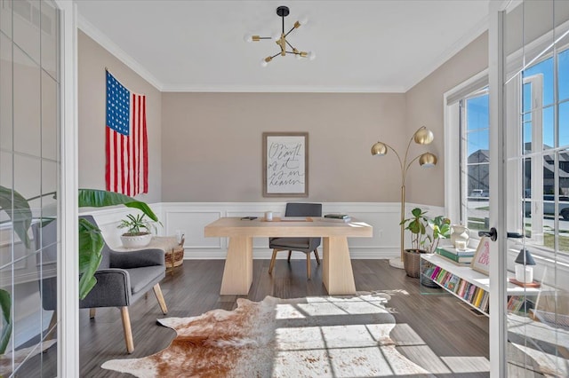 home office with a wainscoted wall, wood finished floors, a chandelier, and crown molding