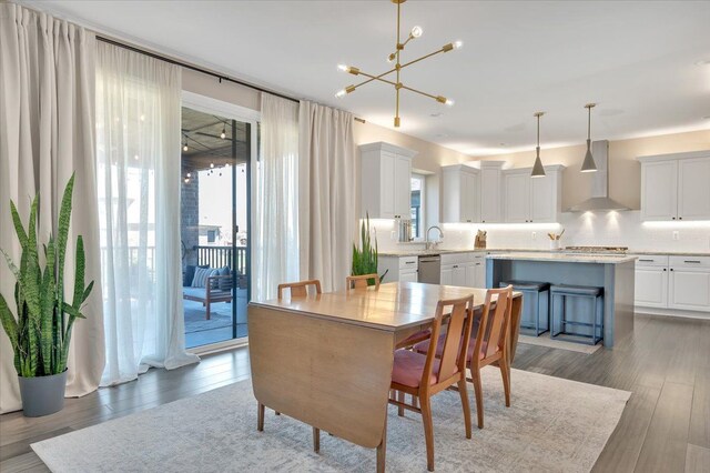 dining area with wood finished floors and a chandelier