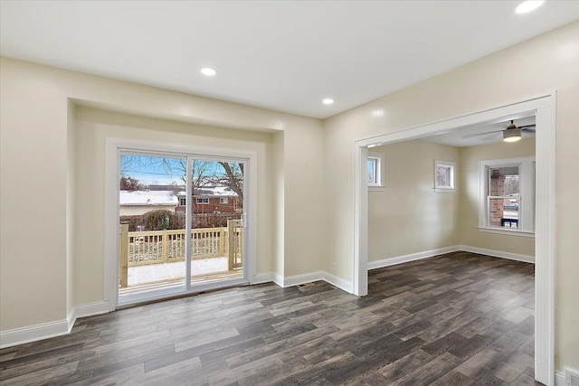 empty room with baseboards, a ceiling fan, dark wood-type flooring, and recessed lighting
