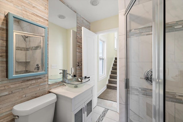 full bath with toilet, vanity, and a stall shower