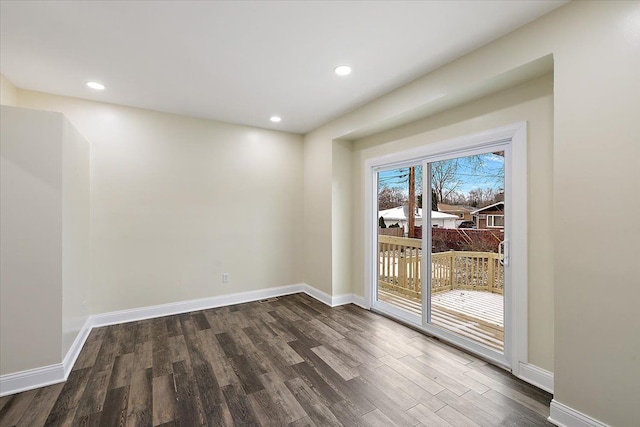 empty room featuring baseboards, recessed lighting, and dark wood finished floors