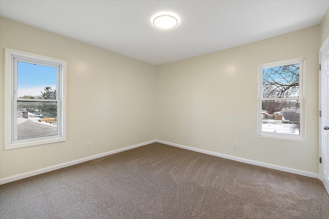 empty room with baseboards and carpet flooring