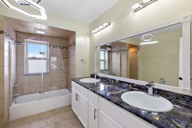 bathroom with shower / bathing tub combination, double vanity, tile patterned floors, and a sink