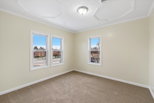 carpeted spare room with a wealth of natural light, baseboards, and ornamental molding