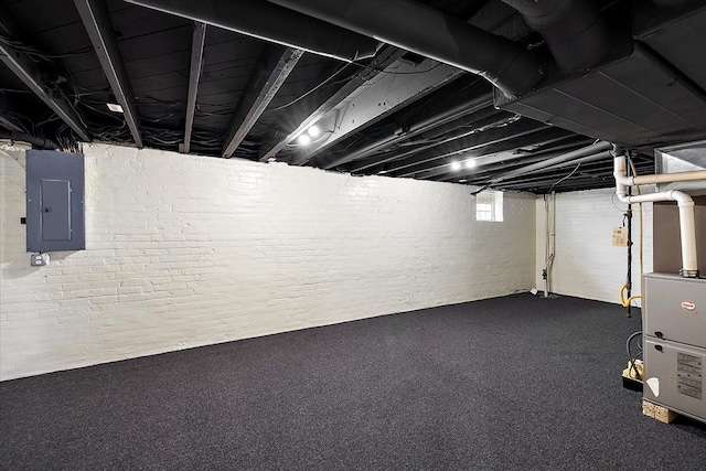 basement featuring heating unit and electric panel