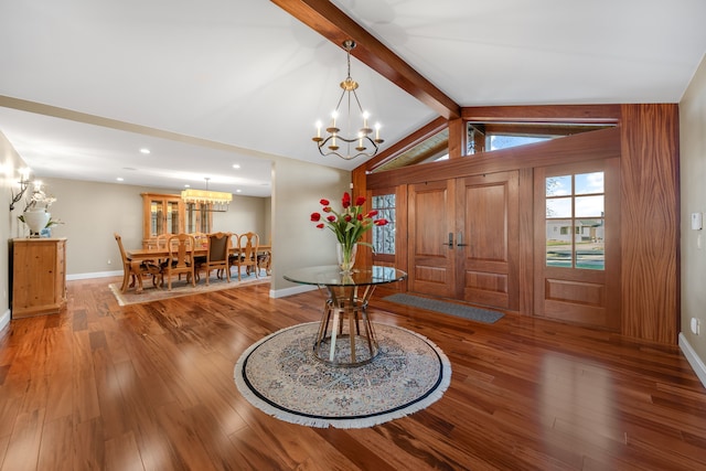 entryway featuring lofted ceiling with beams, baseboards, an inviting chandelier, recessed lighting, and wood finished floors