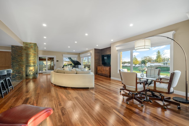 living room featuring baseboards, wood finished floors, and recessed lighting