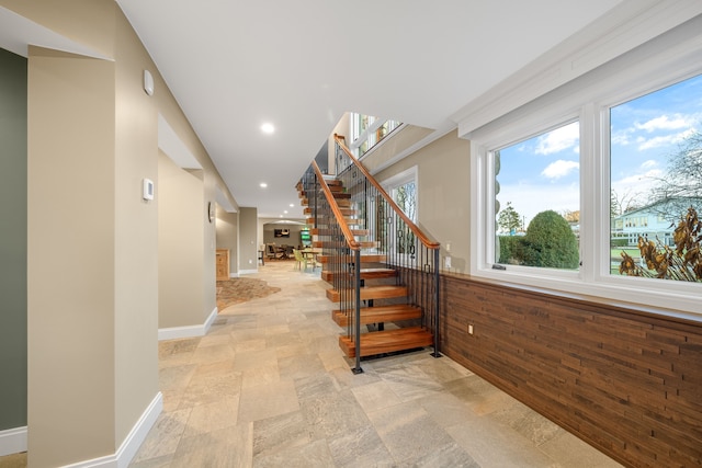 stairway featuring stone finish flooring, baseboards, and recessed lighting
