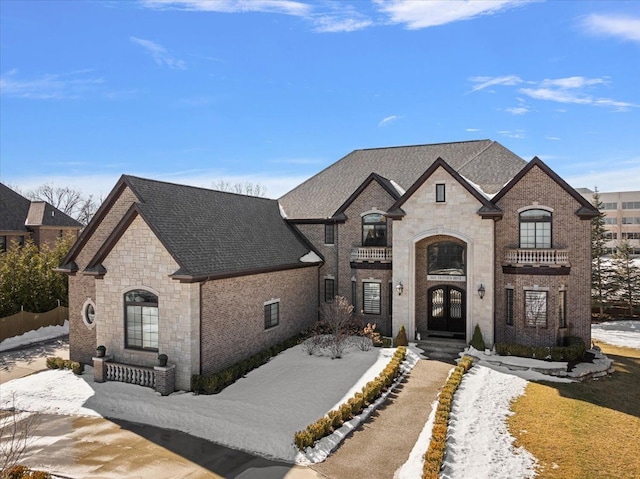 3888 Thatcher Dr, Rochester Hills, MI 48309 - french country home featuring brick siding, french doors, stone siding, and a shingled roof