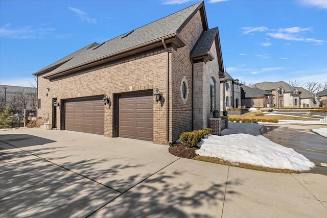 3888 Thatcher Dr, Rochester Hills, MI 48309 - view of property exterior with driveway, a residential view, a garage, brick siding, and roof with shingles