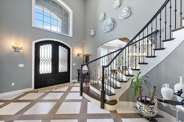 3888 Thatcher Dr, Rochester Hills, MI 48309 - foyer with arched walkways, a high ceiling, baseboards, and a wealth of natural light