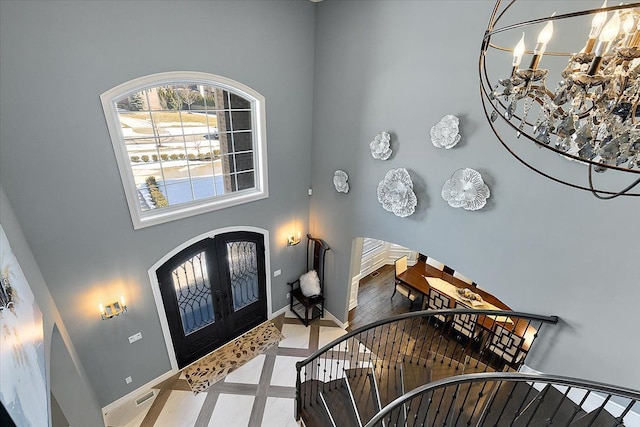 3888 Thatcher Dr, Rochester Hills, MI 48309 - foyer entrance with a towering ceiling, french doors, baseboards, and arched walkways