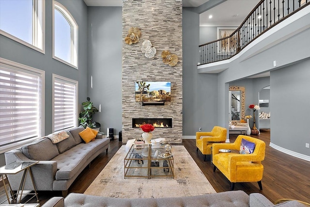 3888 Thatcher Dr, Rochester Hills, MI 48309 - living area with a towering ceiling, a stone fireplace, wood finished floors, and baseboards