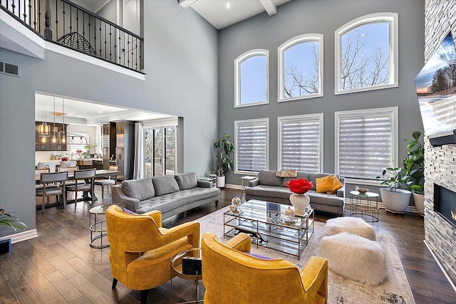 3888 Thatcher Dr, Rochester Hills, MI 48309 - living room with a stone fireplace, wood finished floors, a towering ceiling, and visible vents
