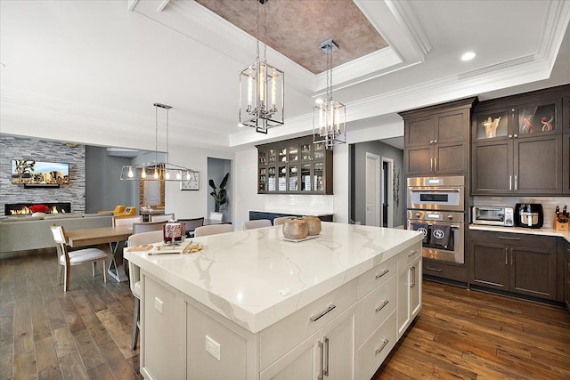 3888 Thatcher Dr, Rochester Hills, MI 48309 - kitchen featuring a tray ceiling, a chandelier, crown molding, and open floor plan