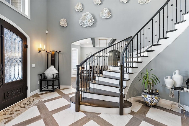 3888 Thatcher Dr, Rochester Hills, MI 48309 - entryway with a high ceiling, baseboards, arched walkways, and stairs