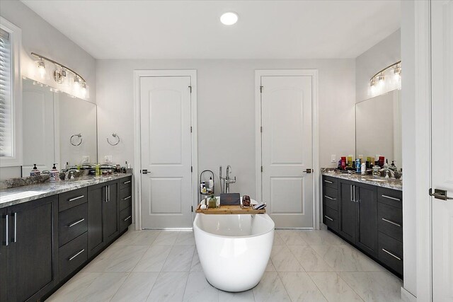 3888 Thatcher Dr, Rochester Hills, MI 48309 - bathroom featuring two vanities, a soaking tub, marble finish floor, and a sink