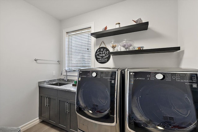 3888 Thatcher Dr, Rochester Hills, MI 48309 - laundry area with a sink, washing machine and dryer, light wood-style floors, baseboards, and cabinet space