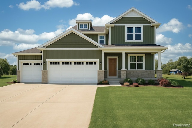 MOH77 Round Rock, Howell, MI 48843 - craftsman-style home with board and batten siding, driveway, a front lawn, and stone siding