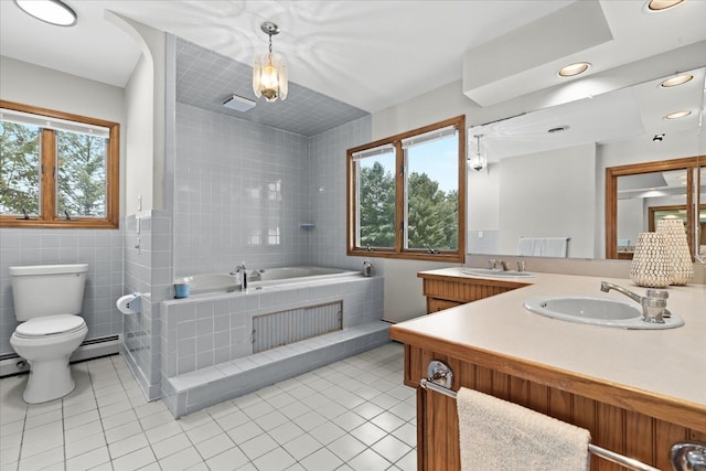 full bathroom with a bath, tile walls, tile patterned flooring, a sink, and toilet