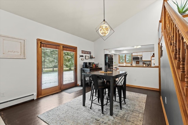 dining area featuring high vaulted ceiling, a baseboard radiator, wood finished floors, and a notable chandelier