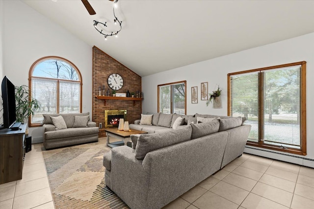 living area with plenty of natural light, a baseboard heating unit, a brick fireplace, and light tile patterned floors
