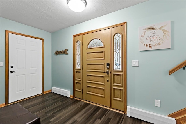 entryway featuring dark wood-type flooring, a textured ceiling, and baseboards