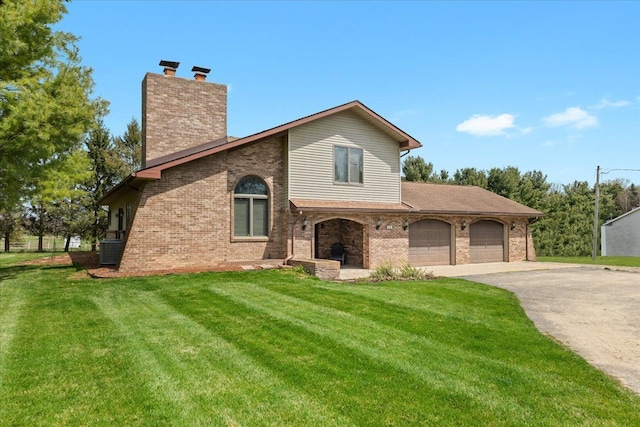 view of front facade featuring a chimney, a front yard, a garage, brick siding, and aphalt driveway