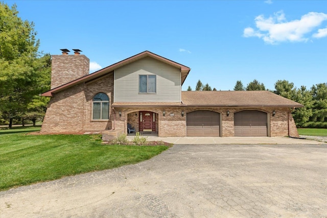 traditional-style house featuring brick siding, aphalt driveway, a front yard, and a garage