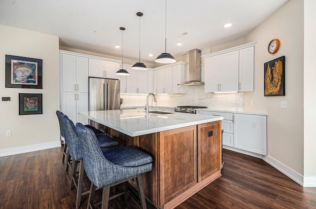 441 S Ashley Unit 306, Ann Arbor, MI 48103 - kitchen featuring a sink, dark wood finished floors, baseboards, freestanding refrigerator, and wall chimney range hood
