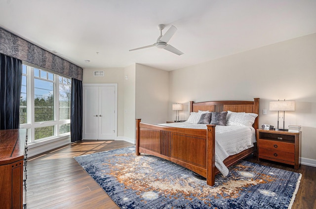 441 S Ashley Unit 306, Ann Arbor, MI 48103 - bedroom featuring baseboards, wood finished floors, visible vents, and ceiling fan