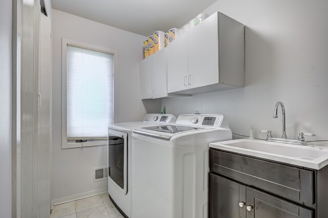 laundry room with visible vents, marble finish floor, baseboards, washing machine and clothes dryer, and cabinet space