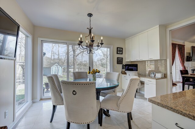 dining room featuring light tile patterned floors and a chandelier