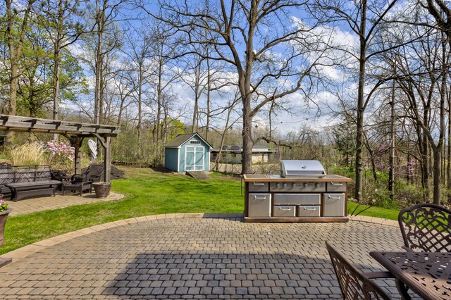view of patio featuring an outdoor structure, a pergola, grilling area, and a shed