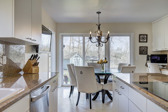 dining room featuring an inviting chandelier, light tile patterned floors, and a wealth of natural light