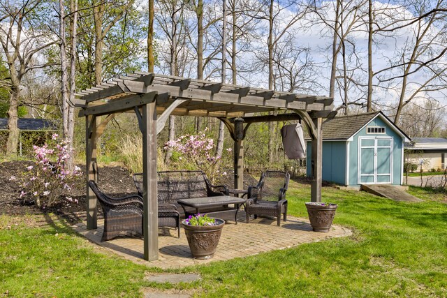 view of yard featuring a pergola, an outdoor structure, a patio area, and a shed