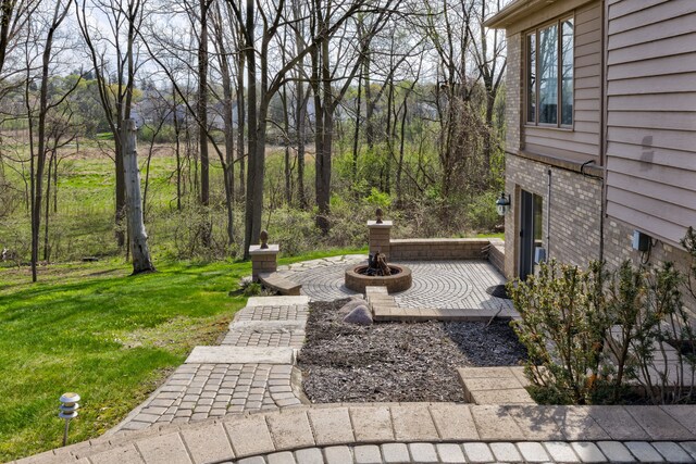 view of yard with an outdoor fire pit