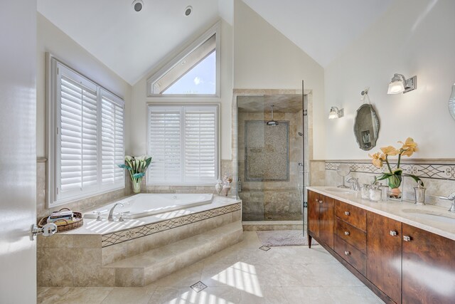 bathroom with double vanity, a sink, a bath, and a shower stall