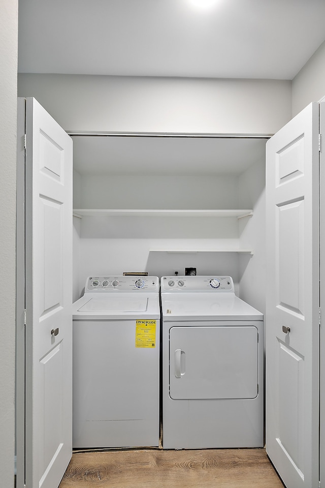 washroom featuring independent washer and dryer and light wood finished floors