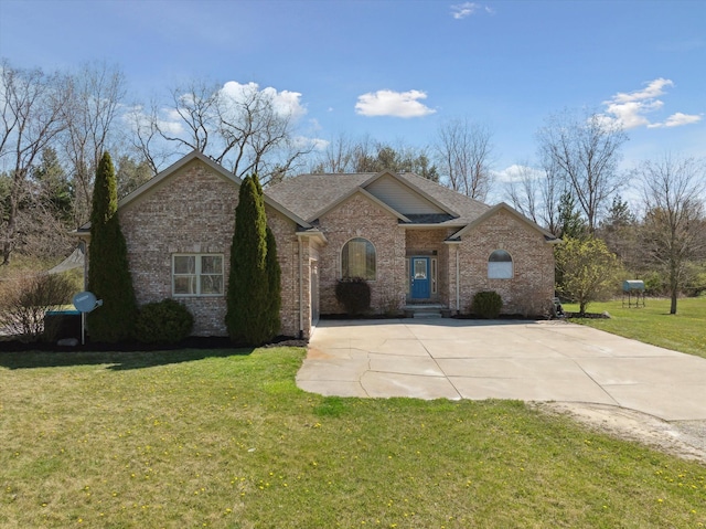 11613 Butler Rd, Willis, MI 48191 - view of front of home featuring brick siding, a shingled roof, and a front lawn