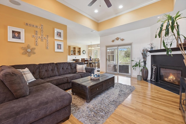 11613 Butler Rd, Willis, MI 48191 - living area with recessed lighting, a fireplace with flush hearth, wood finished floors, a ceiling fan, and crown molding