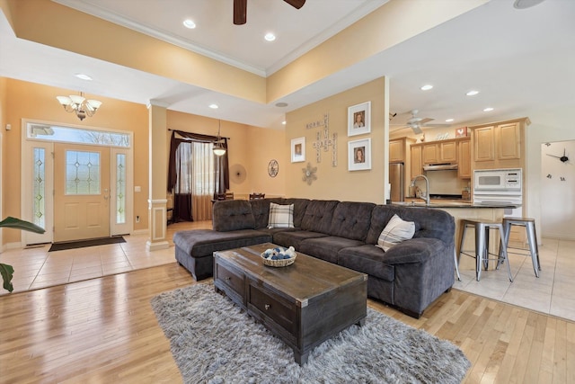 11613 Butler Rd, Willis, MI 48191 - living area with recessed lighting, crown molding, light wood finished floors, and ceiling fan with notable chandelier