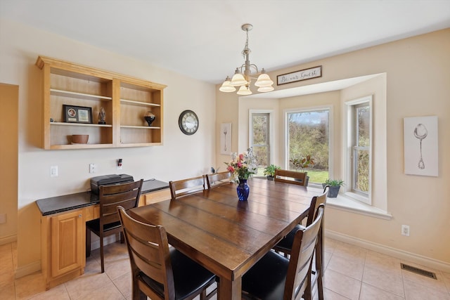 11613 Butler Rd, Willis, MI 48191 - dining space featuring baseboards, a notable chandelier, light tile patterned flooring, and visible vents