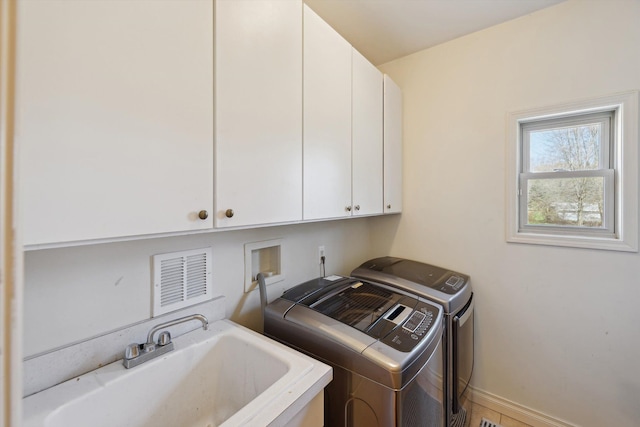 11613 Butler Rd, Willis, MI 48191 - washroom with cabinet space, washer and clothes dryer, visible vents, and a sink