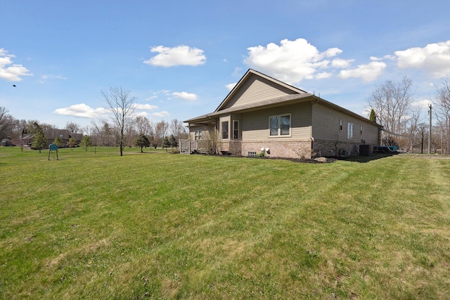 11613 Butler Rd, Willis, MI 48191 - view of side of home with brick siding, a yard, and central air condition unit