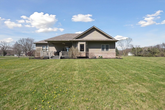 11613 Butler Rd, Willis, MI 48191 - back of house with brick siding, a yard, and a ceiling fan