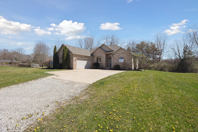 11613 Butler Rd, Willis, MI 48191 - single story home featuring brick siding, a garage, concrete driveway, a front yard, and roof with shingles