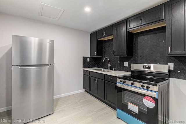 26358 Moses St, Flat Rock, MI 48134 - kitchen with stainless steel appliances, a sink, tasteful backsplash, light wood-type flooring, and light countertops