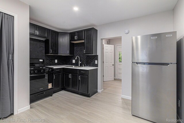 26358 Moses St, Flat Rock, MI 48134 - kitchen with freestanding refrigerator, black range with gas cooktop, a sink, and dark cabinets