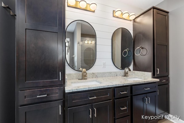 full bathroom featuring a sink and double vanity